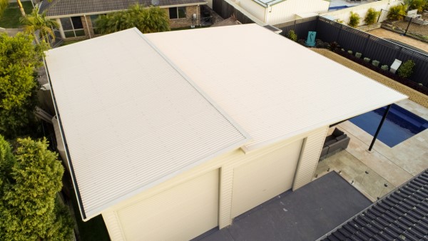 Aerial view of a double garage with an outdoor pool area and an off white steel skillion roof