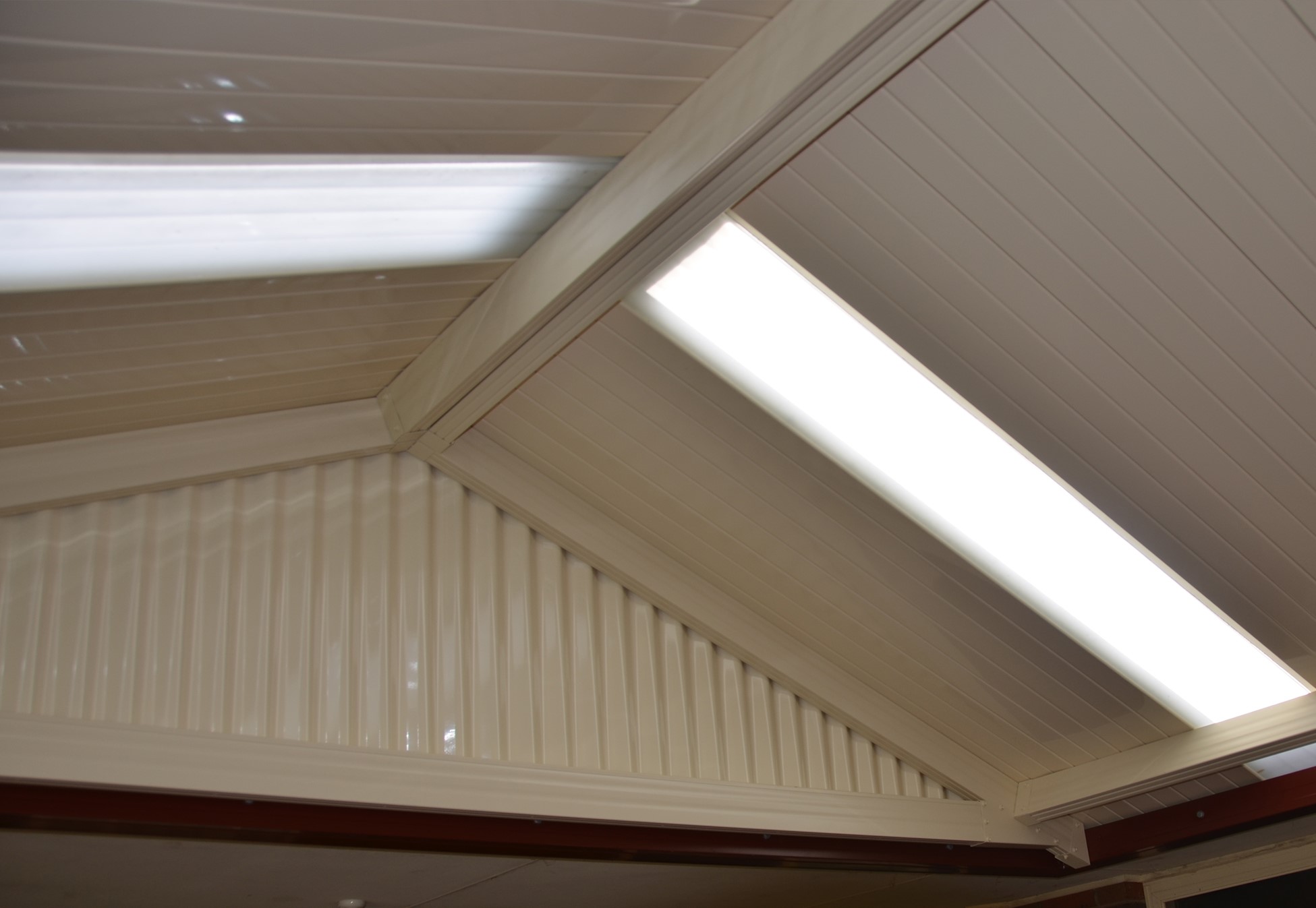 Underside of a gable patio roof with skylight translucent panels 