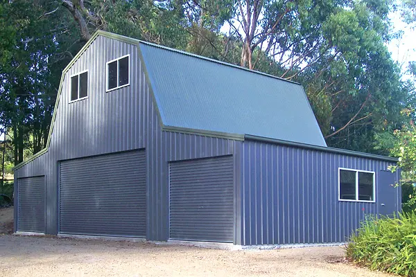 Grey quaker barn with triple roller doors
