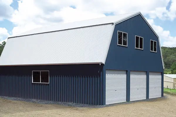 Blue quaker barn with white roller doors
