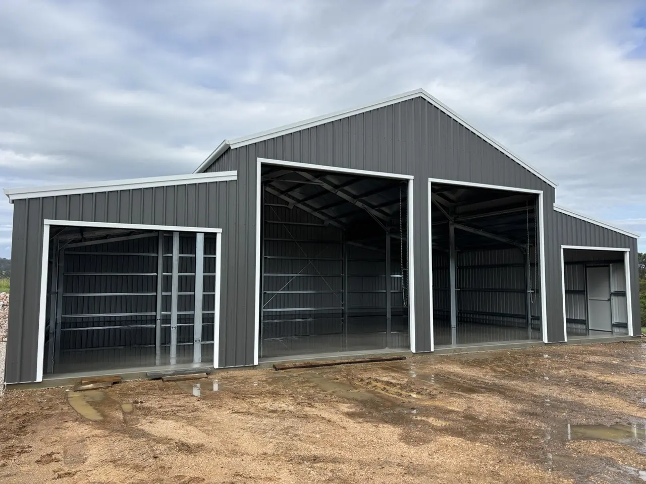 16x12 American Barn, 22 deg roof pitch in main and 11 deg in Lean to's,  4 roller doors, COLORBOND®  Woodland Grey®  and Dover White®  Large