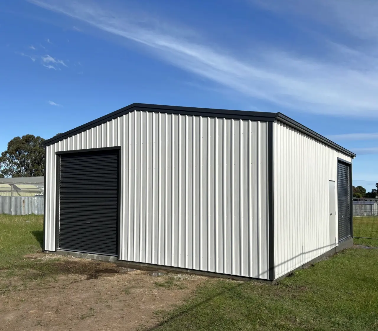 7 x 9 shed, 11 deg pitch, COLORBOND®  Southerly®  and Monument® , 3 roller doors and 1 PA door Large