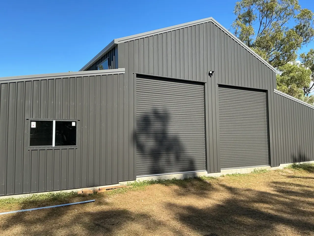 Dark grey barn shed with double roller doors