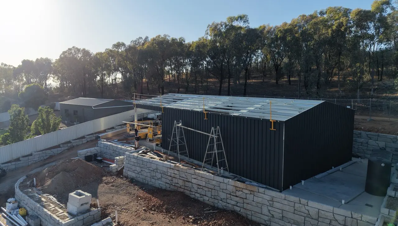 Aerial view of black shed under construction