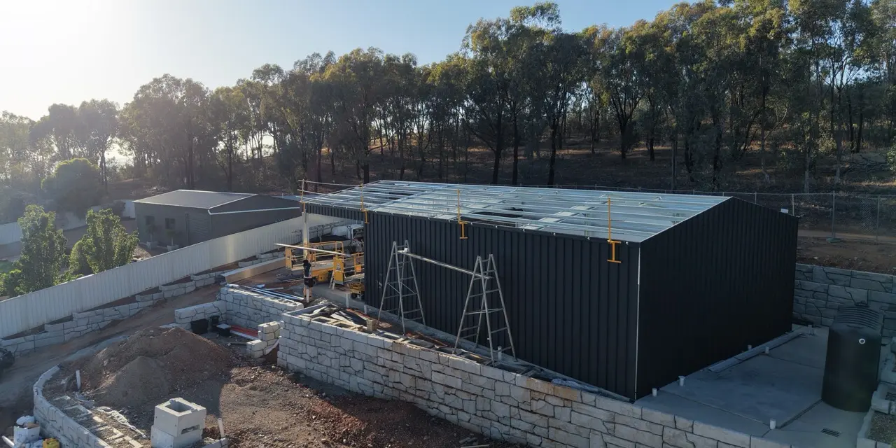 Aerial view of black shed under construction