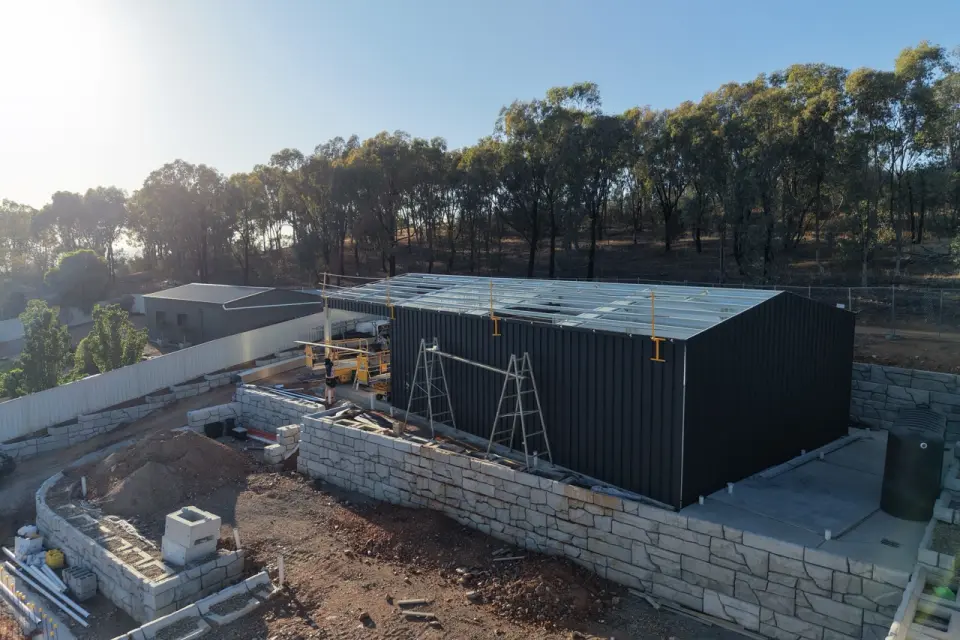 Aerial view of black shed under construction