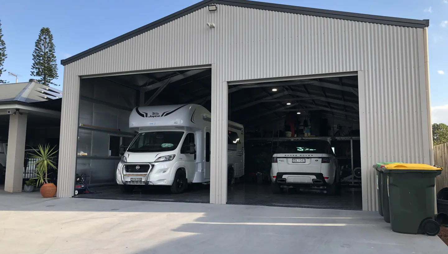 Large steel garage with tall roller doors